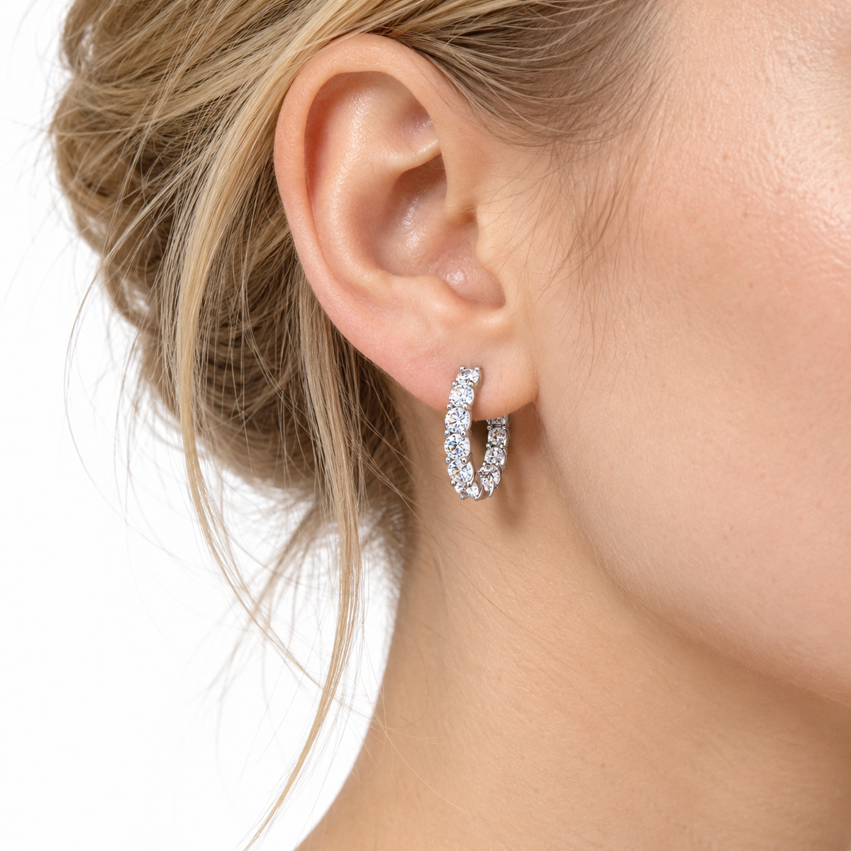 Moissanite inside out hoop earring worn on the ear, sitting close to the lobe